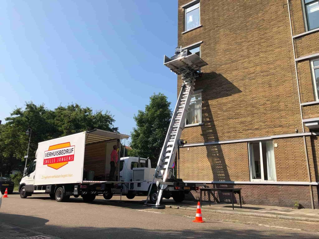 Verhuisbedrijf Snelle Jongens Amsterdam team laadt professioneel een verhuiswagen met beschermingsmaterialen en verhuisdozen
